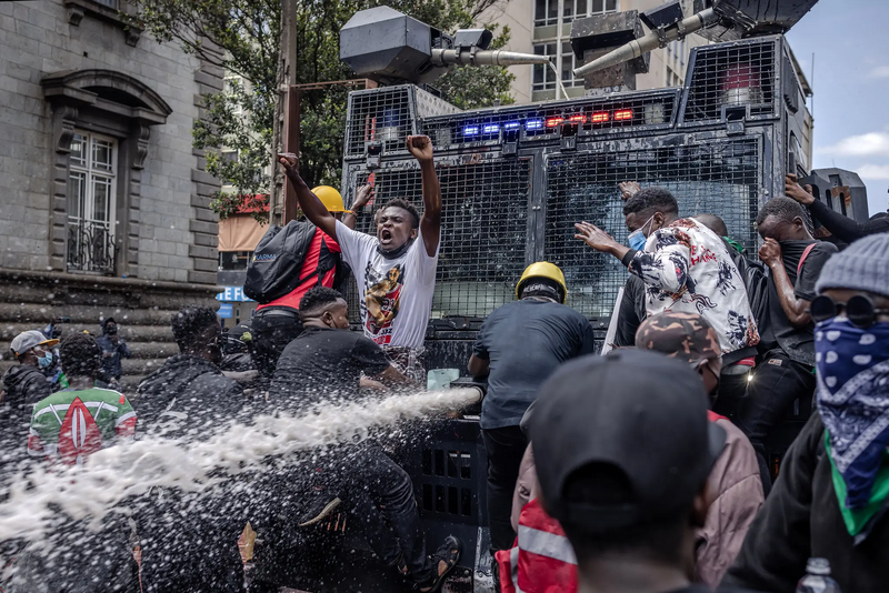 File:Protestor-water-canon.webp